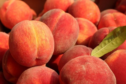Peaches A vibrant assortment of fresh strawberries, raspberries, blueberries, and blackberries arranged together, showcasing their rich colors and textures, perfect for highlighting seasonal fruits or healthy eating.